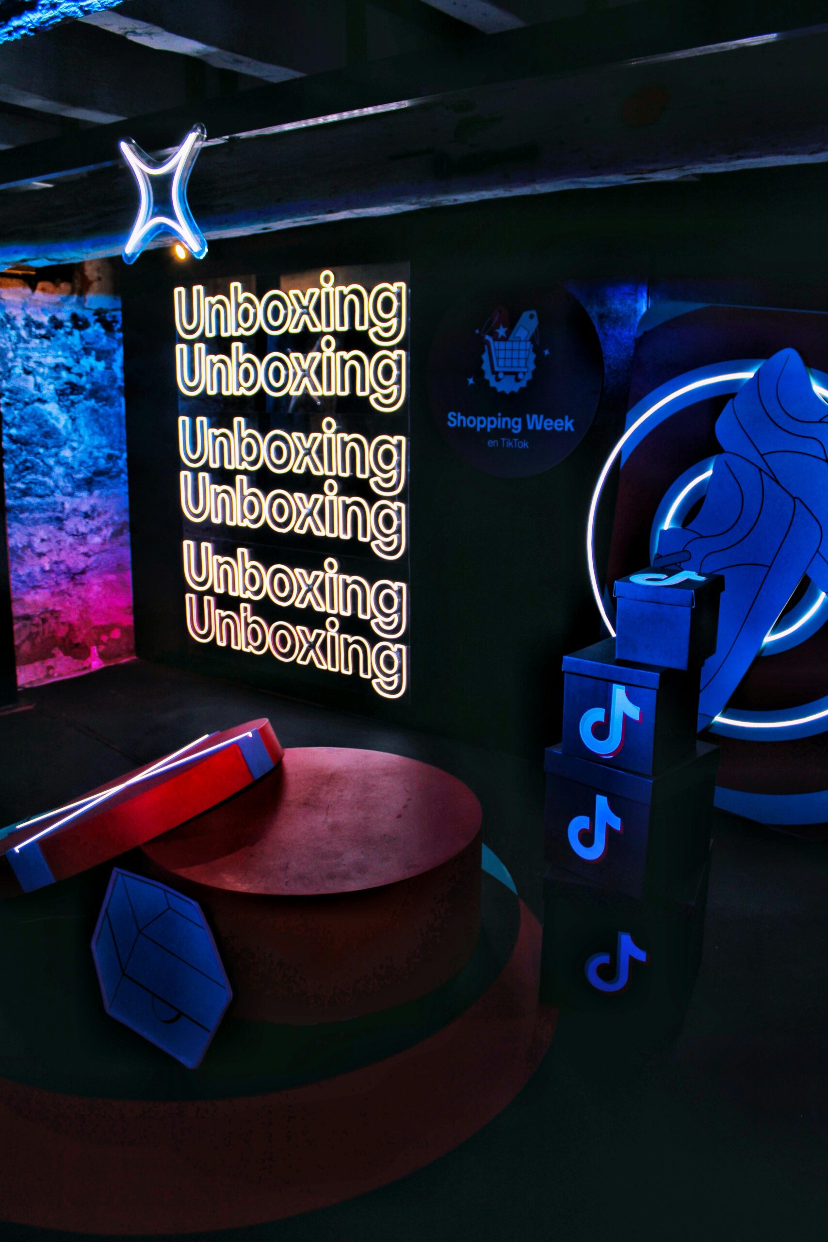Vibrant unboxing event setup with neon lights and digital branding.